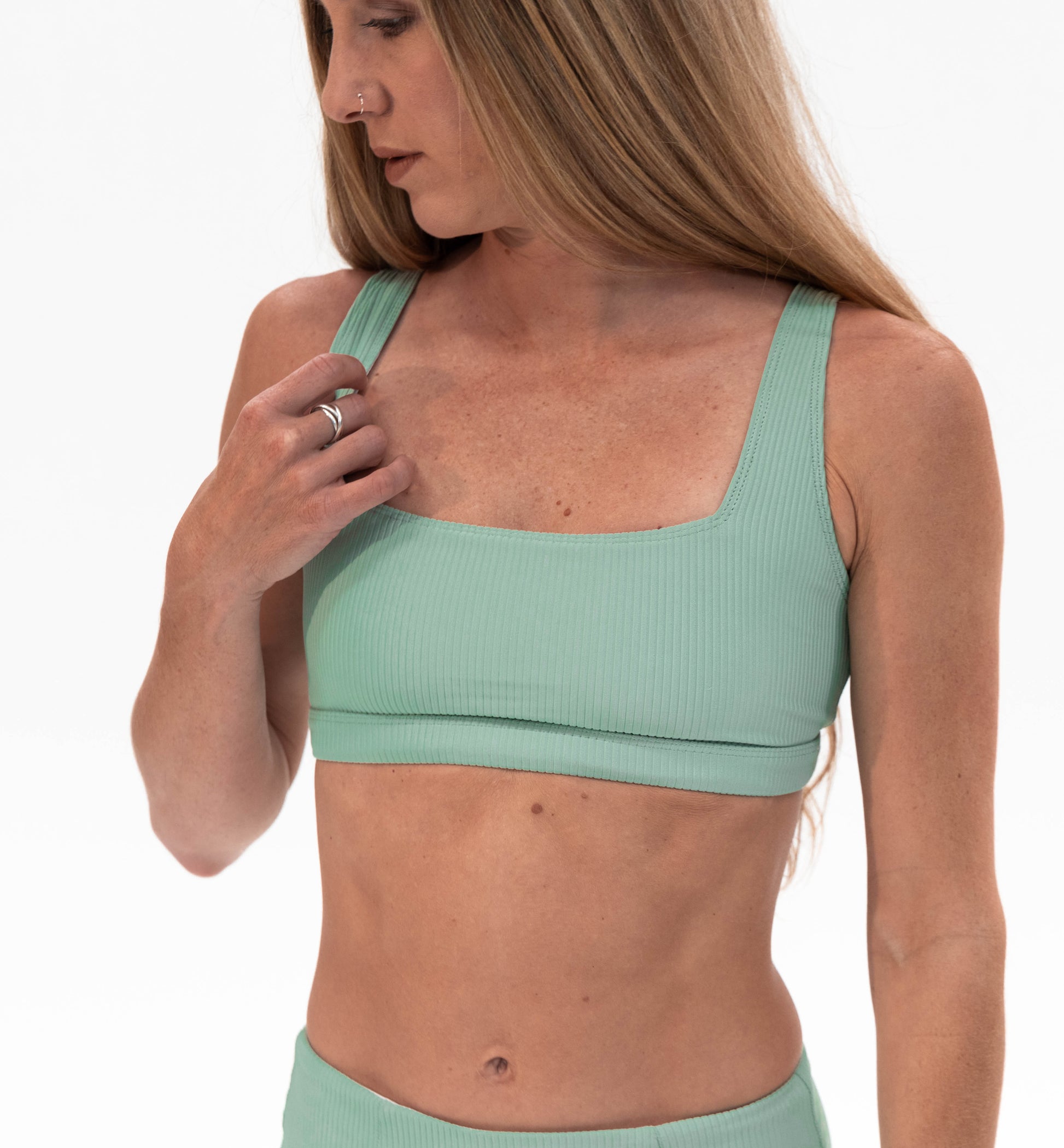 a woman in a green sports bra top