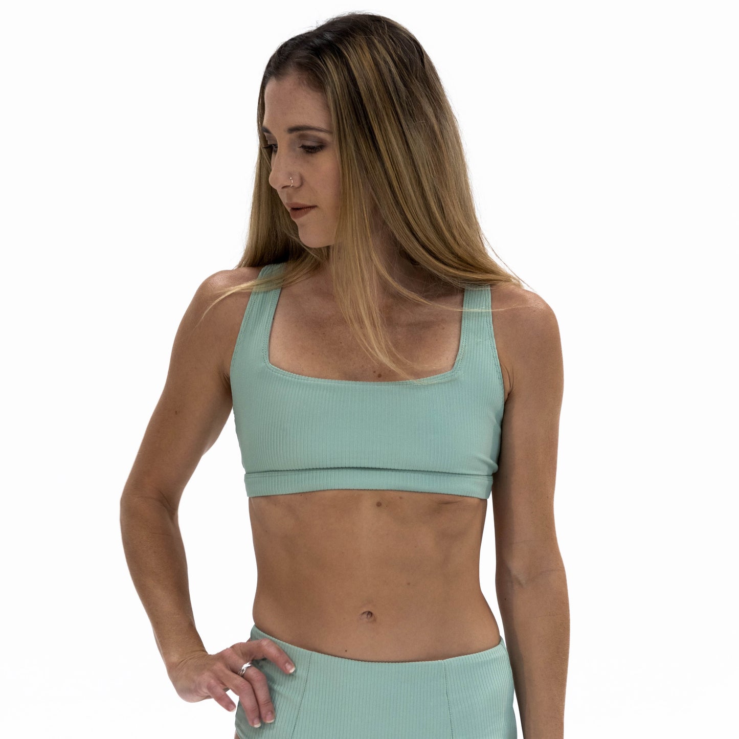 a woman in a green sports bra top