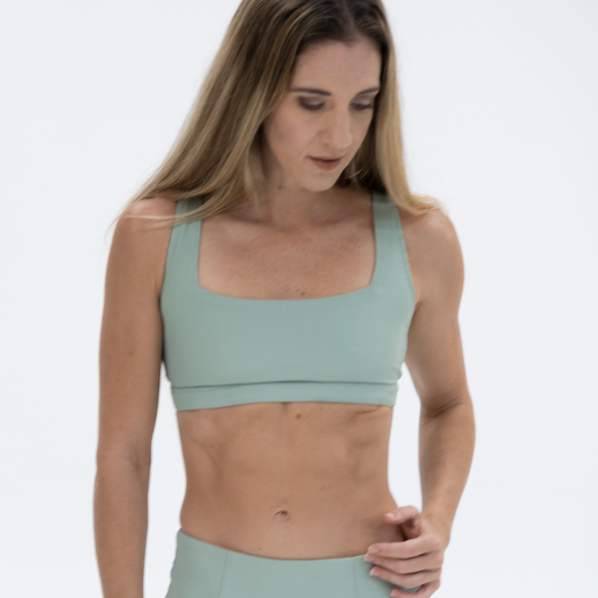 a woman in a green sports bra top